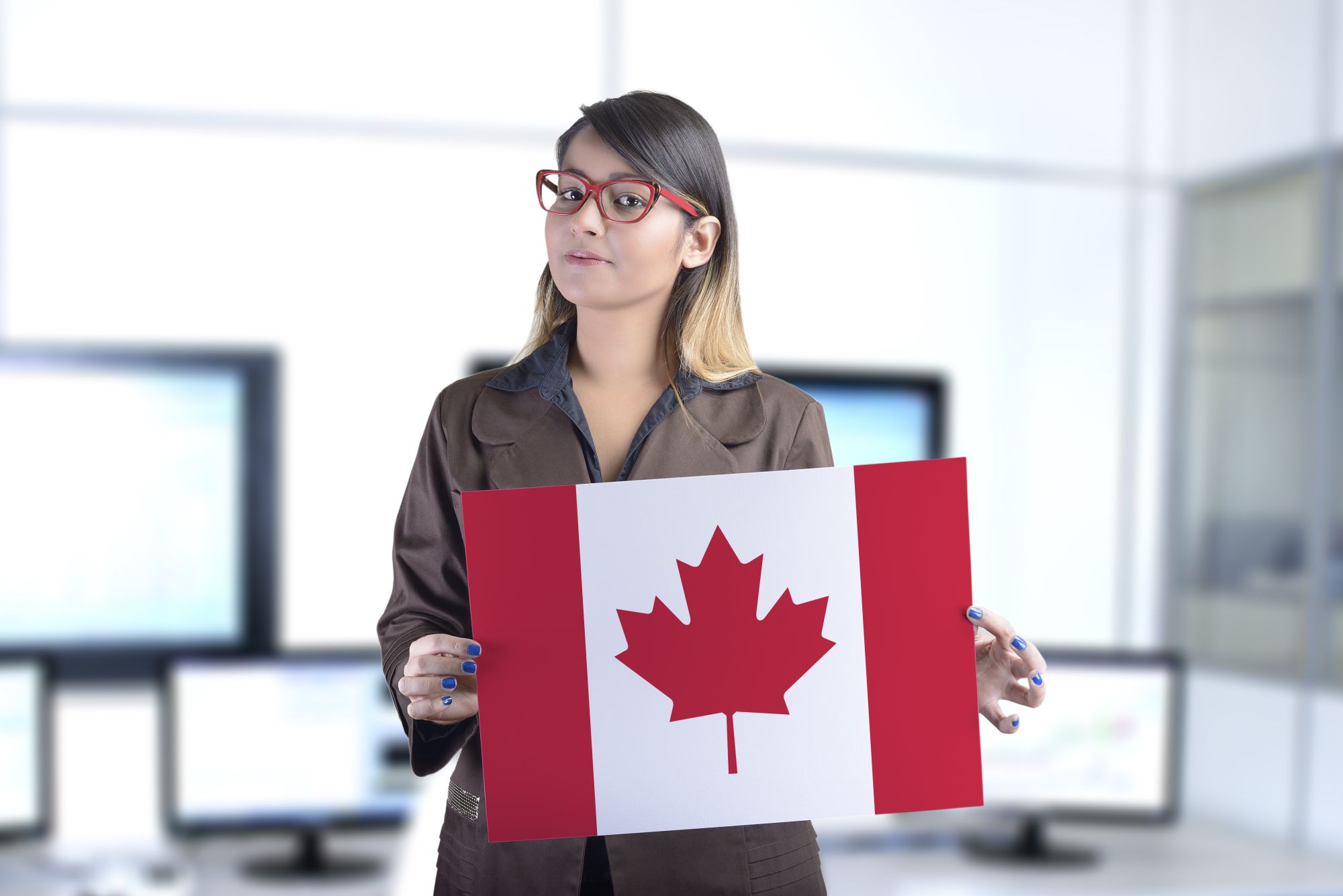 A businesswoman holding the Canadian flag
