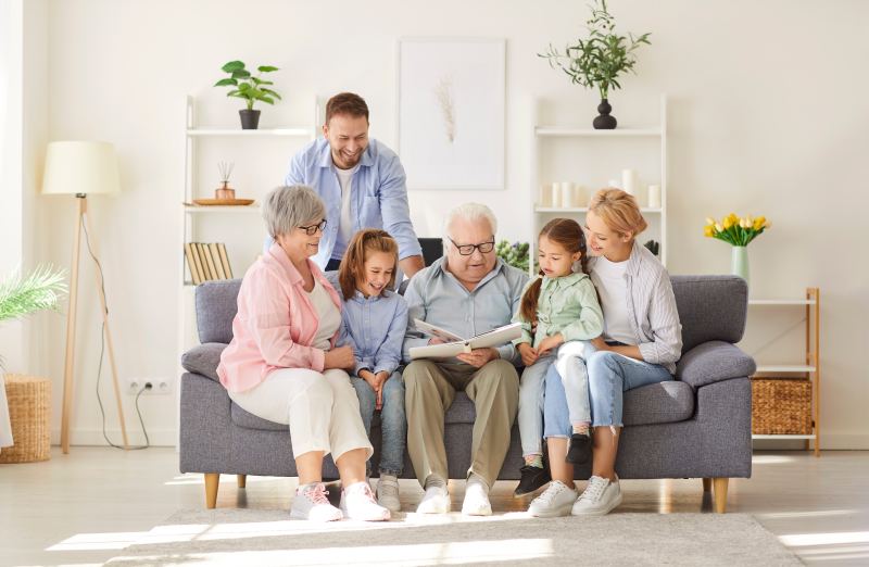 A grandfather showing a family photo album to his grandchildren