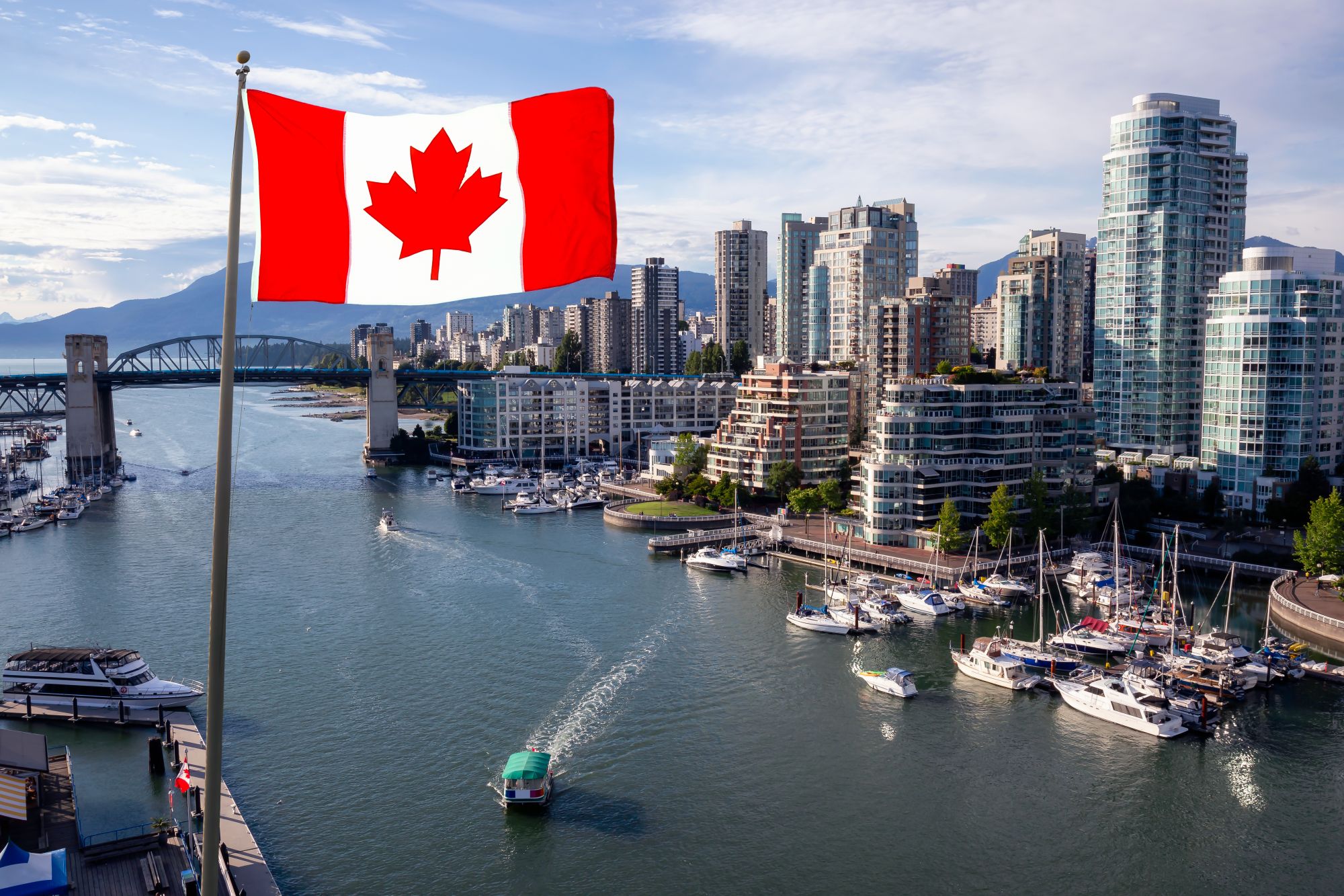 The Canadian flag over downtown Vancouver at sunset